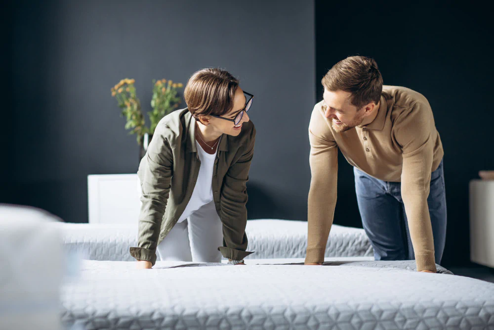 Couple shopping for a mattress in a store