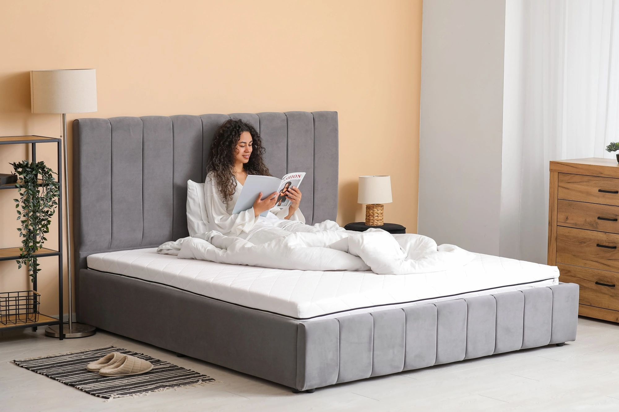 Young woman reading on her bed