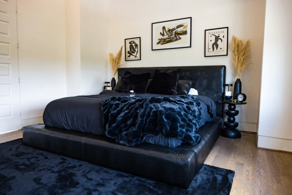 Black leather upholstered bed frame by Living Designs Furniture